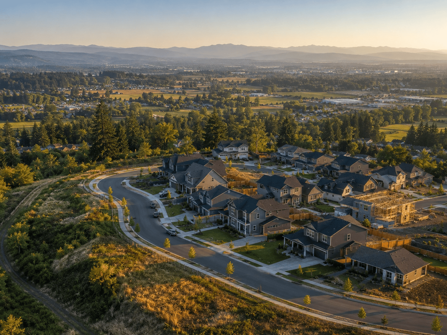 Aerial view of Knox Butte neighborhood in east Albany with new homes and Cascade foothills beyond.